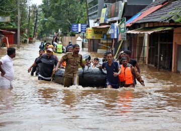 Rescuers evacuate people from a flooded area to a safer place in Aluva in the southern state of Kerala, India, on August 18.