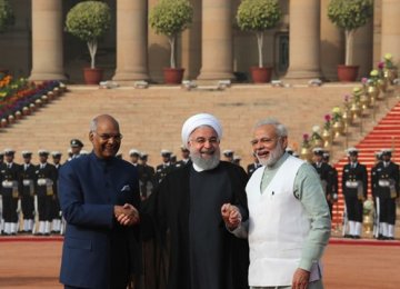 Iranian President Hassan Rouhani (C) holds the hands of Indian President Ram Nath Kovind (L) and Prime Minister Narendra Modi during a ceremonial reception in New Delhi, India, Feb. 17. (AP Photo by Manish Swarup)