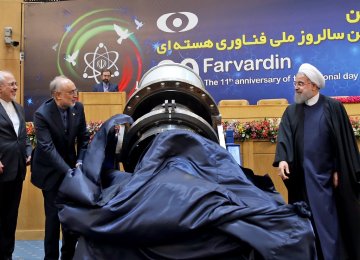 President Hassan Rouhani (R) and AEOI Director Ali Akbar Salehi (C) unveil a high temperature condensate pump in a ceremony in Tehran on April 9 to mark the National Nuclear Technology Day.
