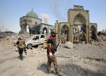 Members of Iraqi Counter Terrorism Service sift through the ruins of the Grand al-Nuri Mosque in Mosul, Iraq June 29.