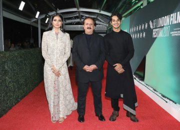 Malavika Mohanan (L), Majid Majidi (C) and Ishaan Khattar on the red carpet of the 61st London Film Festival, October 13.