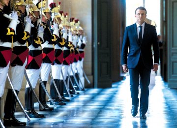 French President Emmanuel Macron walks through the Galerie des Bustes for a special gathering of both houses of parliament outside Paris, on July 3.