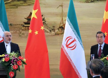 Foreign Minister Mohammad Javad Zarif (L) and his Chinese counterpart, Wang Yi, attend a joint press conference in Beijing on Dec. 5. 