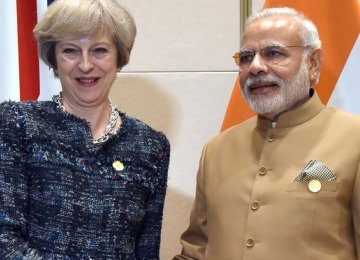 Theresa May (L) and Narendra Modi