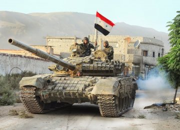 A Syrian Army tank advancing in Aleppo