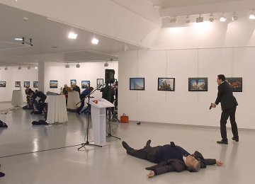 The gunman Mevlut Mert Altintas is seen at the scene of the assassination next to the body of the Russian ambassador, Andrey Karlov.
