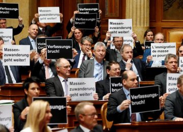 Members of the conservative right Swiss People’s Party held up signs that read “breach of the constitution” and “mass immigration continues”.