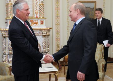 Vladimir Putin (R) shakes hands with Rex Tillerson at a meeting in April 2012. (File Photo)