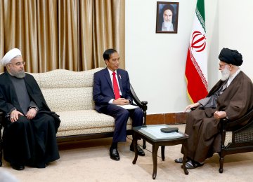 Ayatollah Seyyed Ali Khamenei receives Indonesian President Joko Widodo (C), as President Hassan Rouhani looks on, in Tehran on Dec. 14.