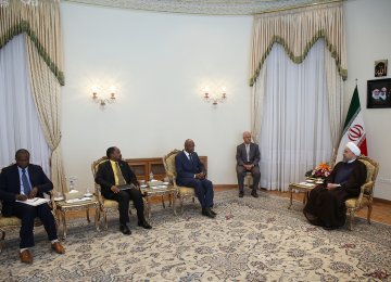 Burundian Foreign Minister Alain Aime Nyamitwe (L) meets President Hassan Rouhani in Tehran on Aug. 16. 