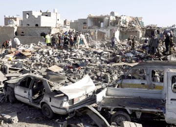 People search for survivors under the rubble of houses destroyed by an airstrike near Sana’a Airport, Yemen. (File Photo)