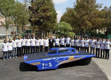 The student team poses with the Iranian Gazelle III at the College of Engineering of the University of Tehran. 
