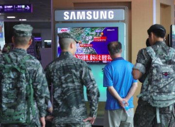 South Korean soldiers watch a television broadcast reporting on North Korea’s latest nuclear test, at a railway station in Seoul on September 9. 