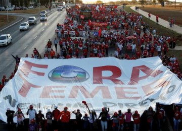 Supporters of Brazil’s suspended President Dilma Rousseff, show a banner that reads ‘Out Temer’ in reference to interim President Michel Temer during the final session of debate and voting on Rousseff’s impeachment trial in Brasilia, Brazil, August 29.