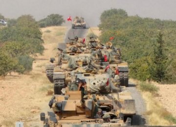 Turkish army tanks make their way towards the Syrian border town of Jarablus, Syria August 24.