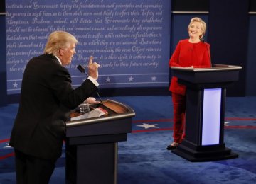 Republican US presidential nominee, Donald Trump, speaks as Democratic US presidential nominee, Hillary Clinton, listens during their first presidential debate at Hofstra University in Hempstead, New York, USA, on Sept. 26.