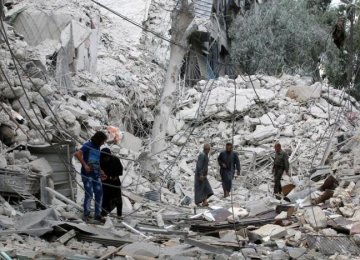 People inspect a damaged site after airstrikes on the militant held Tariq al-Bab neighborhood of Aleppo, Syria, on Sept. 23.