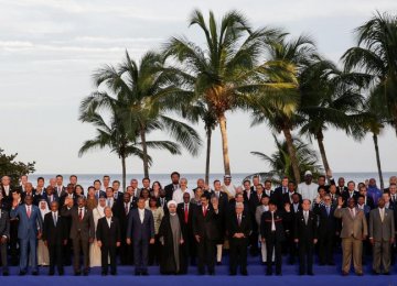 Venezuela’s President Nicolas Maduro (C-R), Iranian President Hassan Rouhani (C-L) and other presidents, leaders and head of delegations pose for a family photo during the 17th Non-Aligned Summit in Porlamar, Venezuela, on Sept. 17.