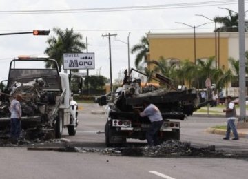 Burned-out vehicles were left on the road after the ambush on a military convoy in Sinaloa.