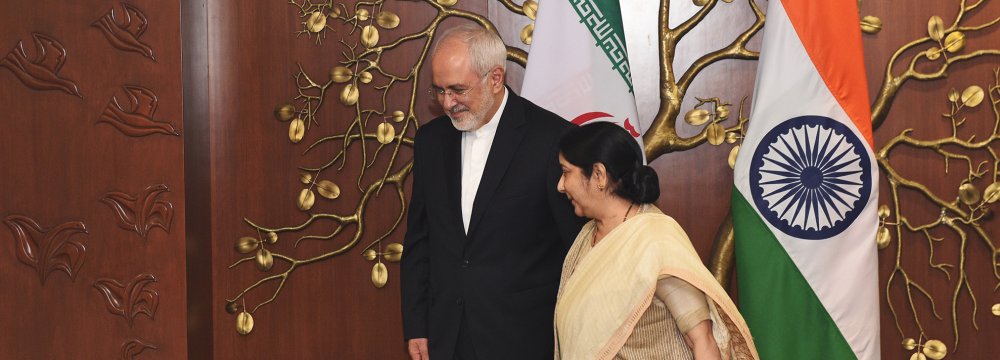 Indian Minister of Foreign Affairs Sushma Swaraj (R) walks next to her Iranian counterpart Mohammad Javed Zarif before a meeting in New Delhi on May 28.