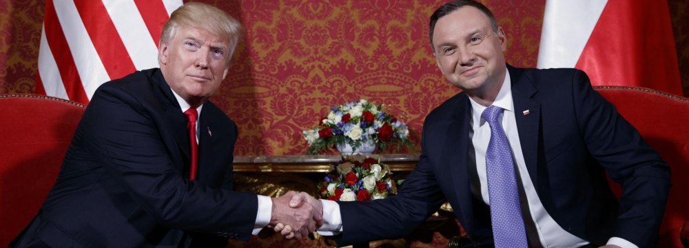 US President Donald Trump (L) and Polish President Andrzej Duda shake hands during their meeting in Warsaw on July 6, 2017. 
