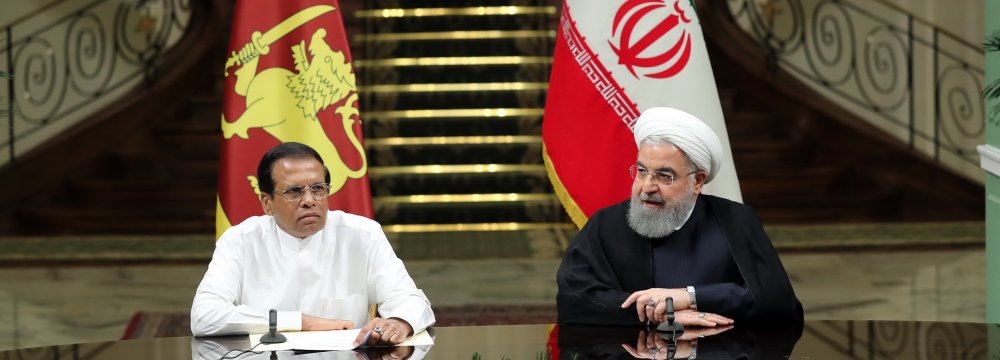 Iranian President Hassan Rouhani (R) meets with his Sri Lankan counterpart, Maithripala Sirisena, in Tehran on Sunday. 