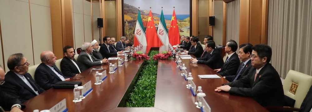 Top-level Iranian and Chinese officials confer as part of meetings that led to the signing of four major MoUs in Qingdao.