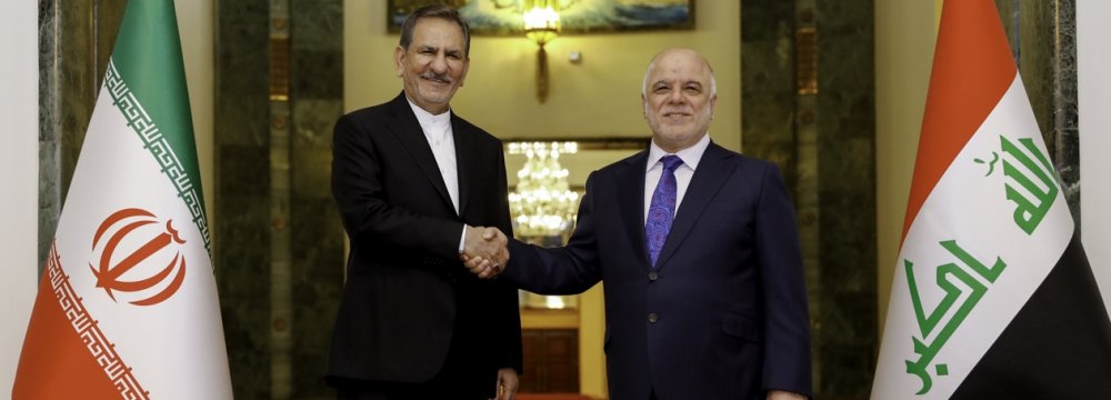 Iran’s First Vice President Es’haq Jahangiri (L) shakes hands with Iraqi President Fuad Masum in Baghdad on March 8.