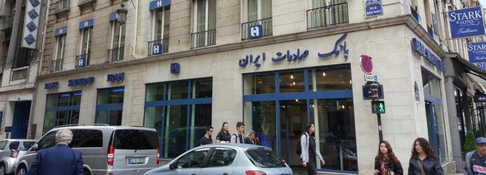 People walk by the Paris branch of Bank Saderat Iran.  
