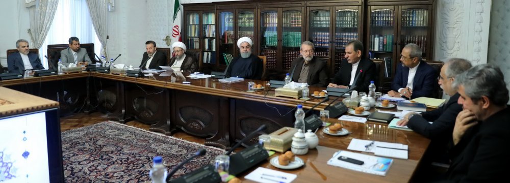 President Hassan Rouhani, flanked by Parliament Speaker Ali Larijani (R) and Judiciary Chief Ayatollah Sadeq Amoli Larijani, attended the meeting in Tehran on June 19. 