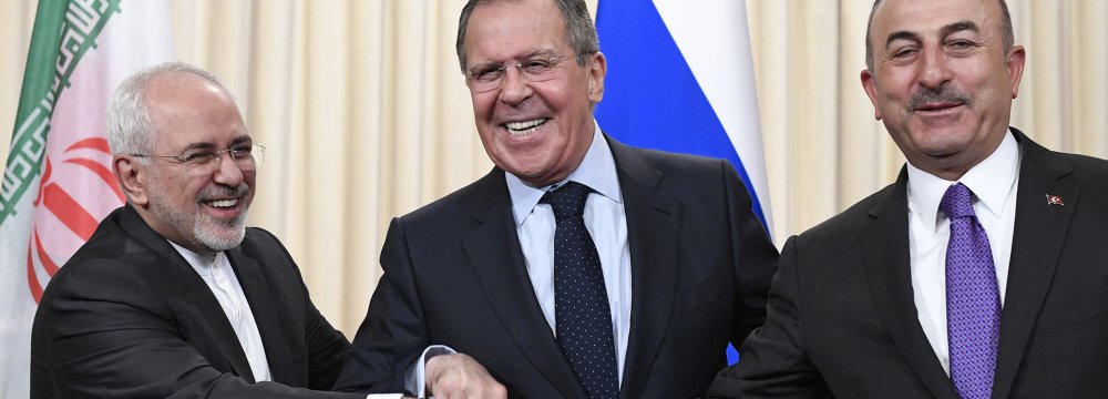 Mohammad Javad Zarif (L), Sergey Lavrov (C) and Mevlut Cavusoglu shake hands at the end of a joint press conference following their talks in Moscow on April 28.