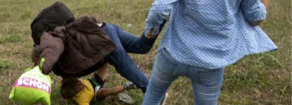 Hungarian TV Journalist Filmed  Kicking Refugee Kids