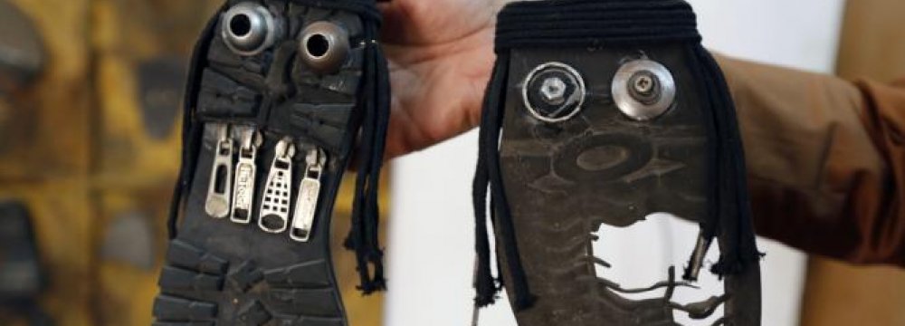 Iraqi Artist Shows ‘Ugly Faces’ of IS With Old Shoes