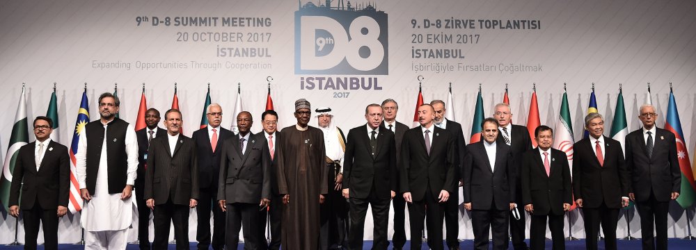Participants pose for a family photo during the opening ceremony of D8 Organization for Economic Cooperation Summit in Istanbul on Oct. 20.