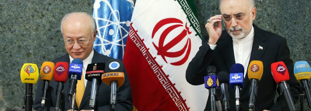 IAEA Director General Yukiya Amano (L) and Iran's nuclear chief, Ali Akbar Salehi, attend a presser in Tehran on Oct. 29.	