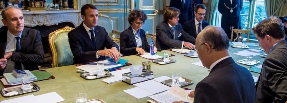 French President Emmanuel  Macron (2nd L) meets IAEA chief  Yukiya Amano (R) in Paris on Oct. 19.  