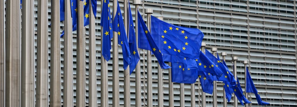 EU flags fly in front of its headquarters in Brussels.	