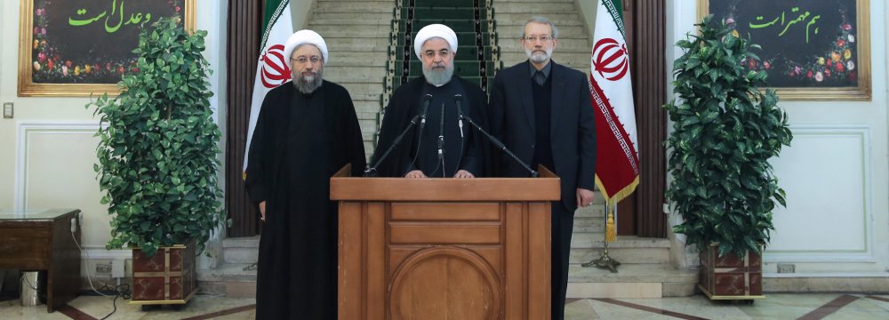 President Hassan Rouhani is flanked by Majlis Speaker Ali Larijani (R) and Judiciary Chief Sadeq Amoli Larijani in Tehran on Nov. 11.