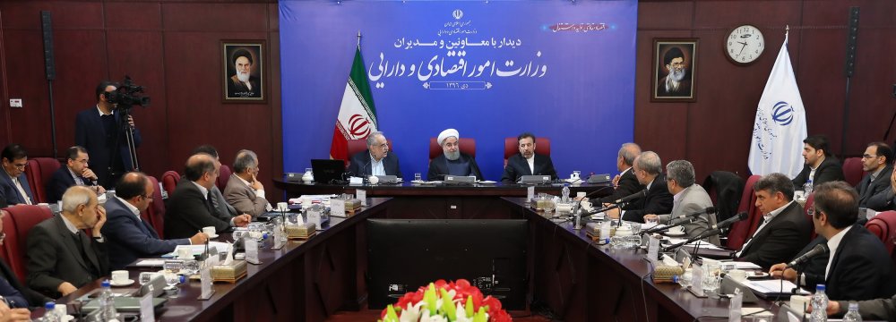 President Hassan Rouhani meets top Economy Ministry officials in Tehran on Jan 8.	