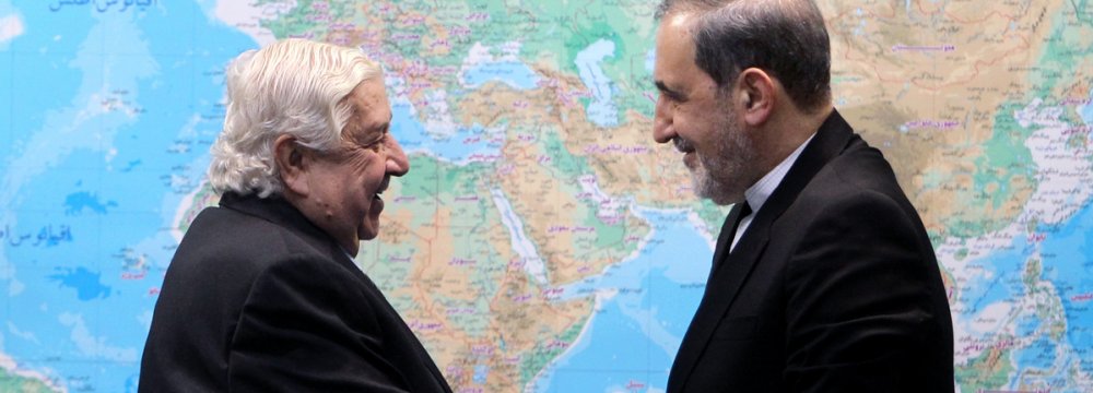 Syrian Foreign Minister Walid Muallem (L) shakes hands with Ali Akbar Velayati, a foreign policy advisor to the Leader of Islamic Revolution, in Tehran on Jan. 1. 