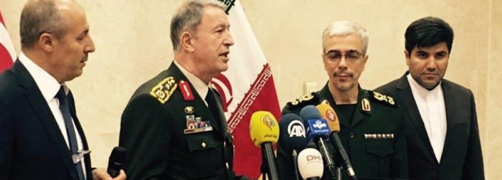 Iranian and Turkish military chiefs attend a press conference in Tehran on Oct. 2.  