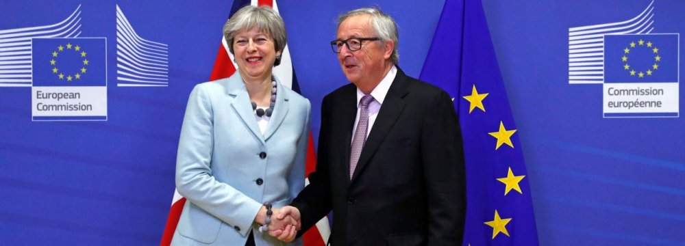 Prime Minister Theresa May is welcomed by European Commission President Jean-Claude Juncker in Belgium, December 8.