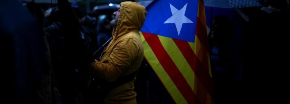 A demonstrator holds an Estelada (Catalan separatist flag) during a gathering in front of the Spanish Central Government headquarters in Barcelona on October 19.