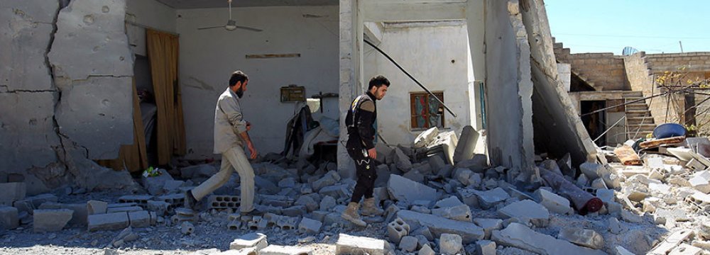 Civil defense members inspect the damage at a site hit by airstrikes in the town of Khan Sheikhoun, Syria, on April 5.