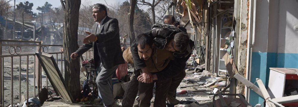 A victim being carried from the site of the bombing in Kabul, Afghanistan, on Jan. 27.  The city’s hospitals were overwhelmed by the number of wounded. 