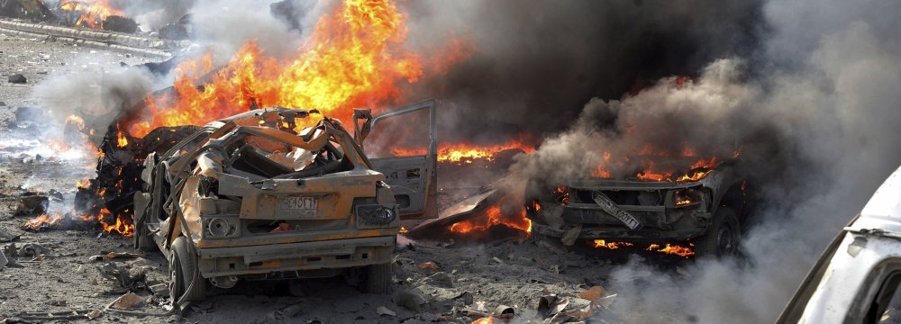 Cars burn at the scene of the bomb attack in Rukban Refugee Camp, Syria, May 15.