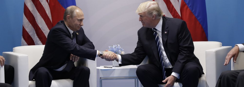 US President Donald Trump (R) shakes hands with Russian President Vladimir Putin during their meeting  on the sidelines of the G20 summit in Hamburg on July 7.