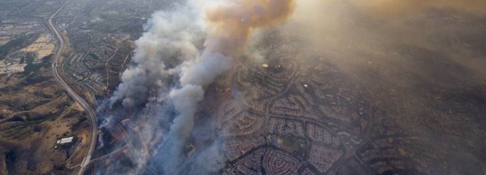 A wildfire moves closer to North Tustin homes along the 261 freeway in Tustin, Calif. on Oct. 9. 
