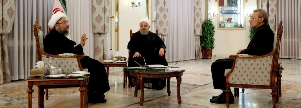 President Hassan Rouhani is flanked by Judiciary Chief Sadeq Amoli Larijani (L) and Parliament Speaker Ali Larijani in Tehran on Nov. 11.
