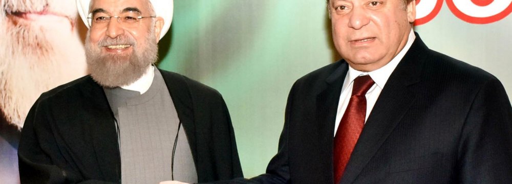 Iranian President Hassan Rouhani (L) shakes hands with Pakistani Prime Minister Nawaz Sharif in Islamabad. (File Photo)